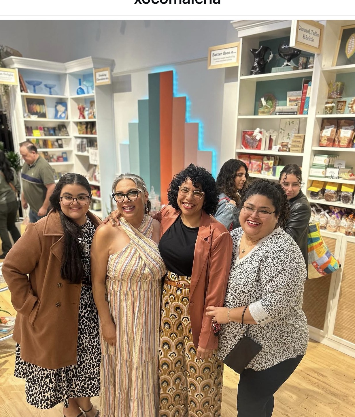 Friends and staff celebrating inside the chocolate shop